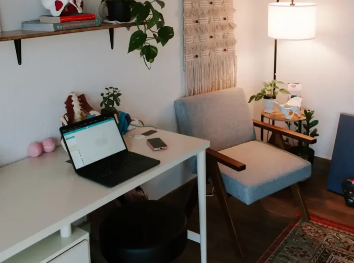Lumbar spine model and open laptop on the white clinic desk